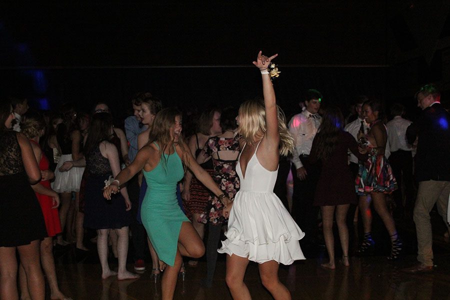 Students smile as they dance with friends at the Homecoming Dance on Saturday, Sept. 17. The dance shows StuCo’s “Escape to Rio 2016” theme with Olympics and Rio decorations.