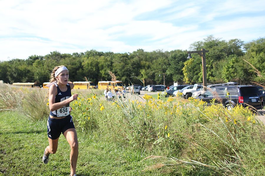 Freshman Annie Hoog sprints to cross the finish line during the 5000 meter race on Saturday, Sept. 10.