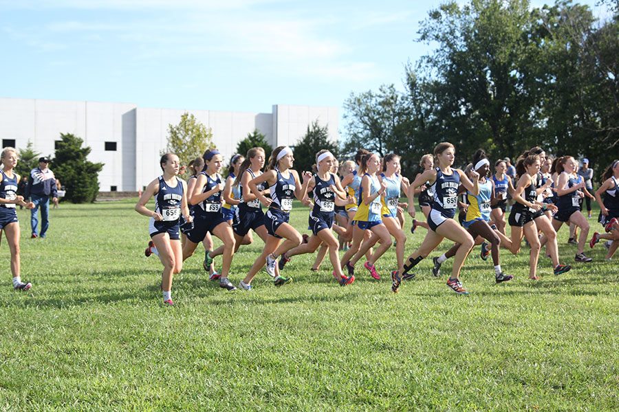 The girls varsity cross country team starts off strong during the 5000 meter race.