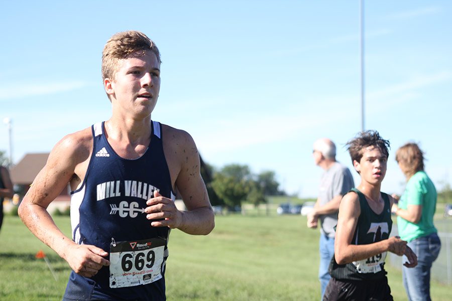 Junior Mitch Dervin overtakes an opponent during the 5000 meter race.