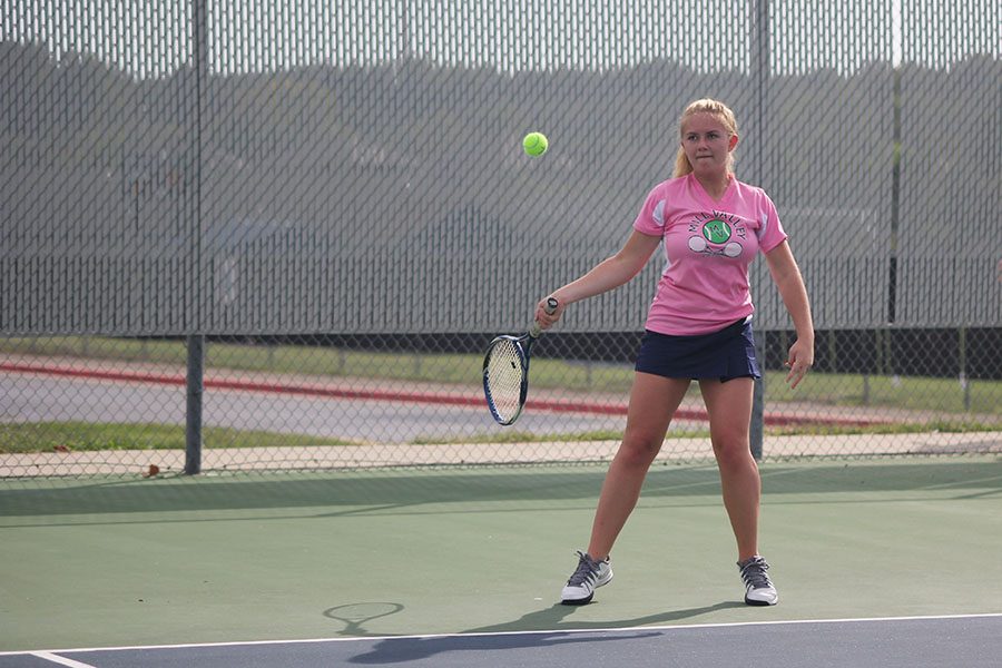 Junior Annie Casburn watches the ball as it comes towards her racket. 