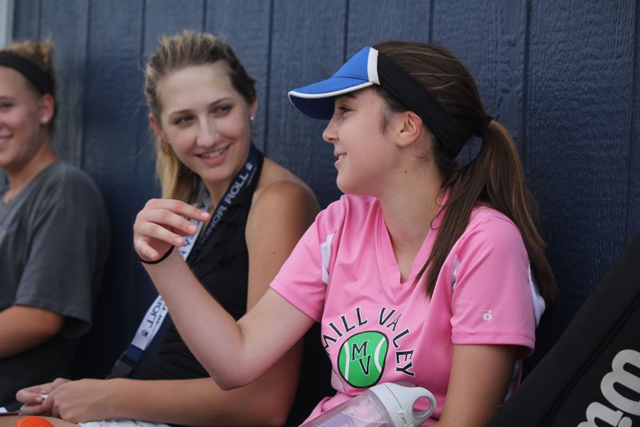 Between her games, junior Tori Benson tells junior Madison VanBuhler a story on Tuesday, Sept.  20.