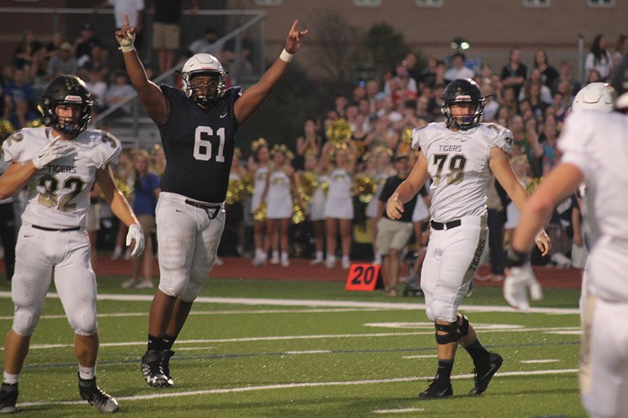 After the football team scored a touchdown,  senior offensive lineman Alec Derritt celebrates with his team.