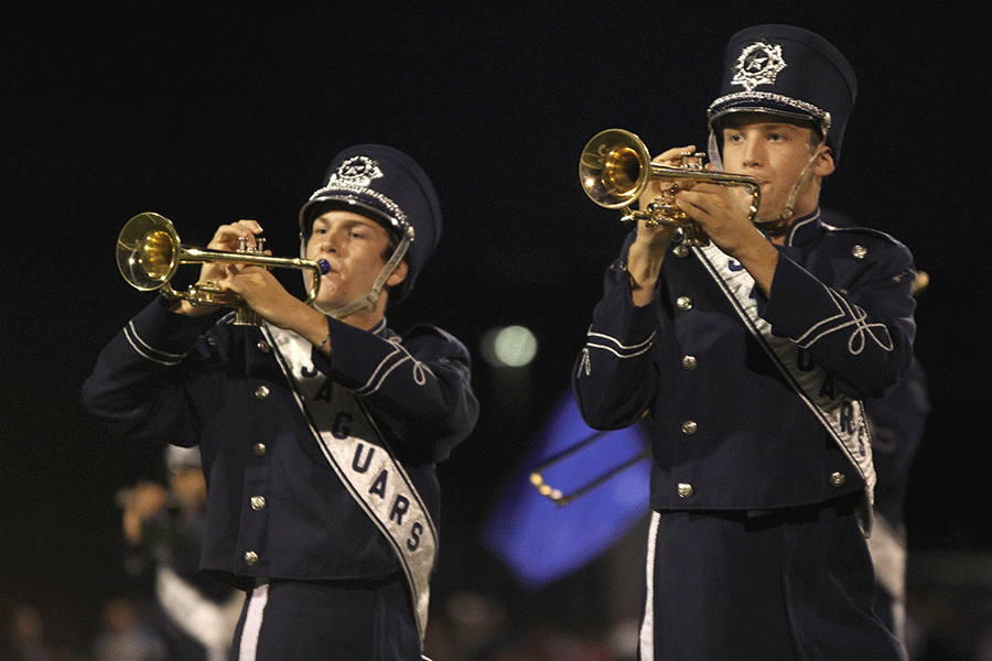 While playing their trumpets, seniors Adam Gillette and Dawson Cantwell move in formation during halftime on Friday, Sept. 2.