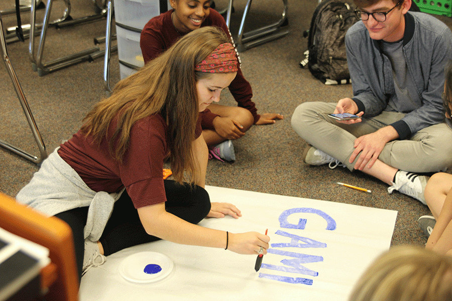 At the Make-A-Wish meeting on Friday, Sept. 9, senior Claire Rachwal creates a poster for the organizations homecoming parade float.