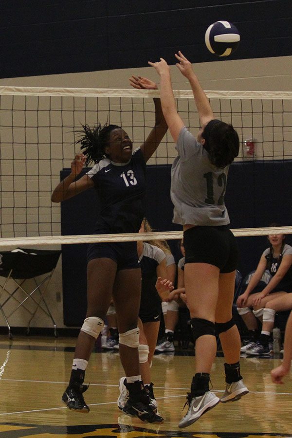 Junior Abigail Archibong springs to the net to return the ball to her opposers.