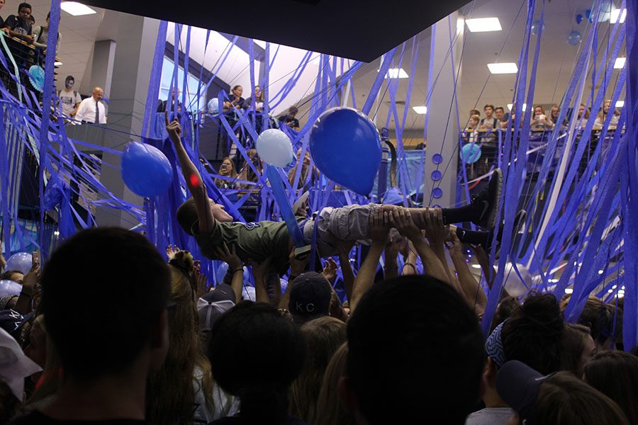 Griffin Hey body surfs a crowd of seniors after mass decorating the school.