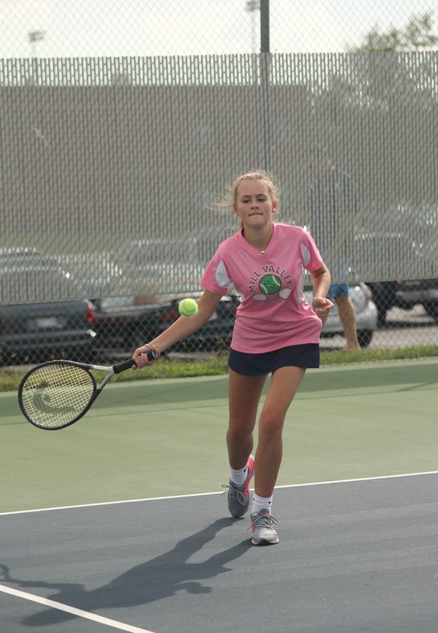 Junior Emmerson Hall focuses on swinging her racket towards the ball.