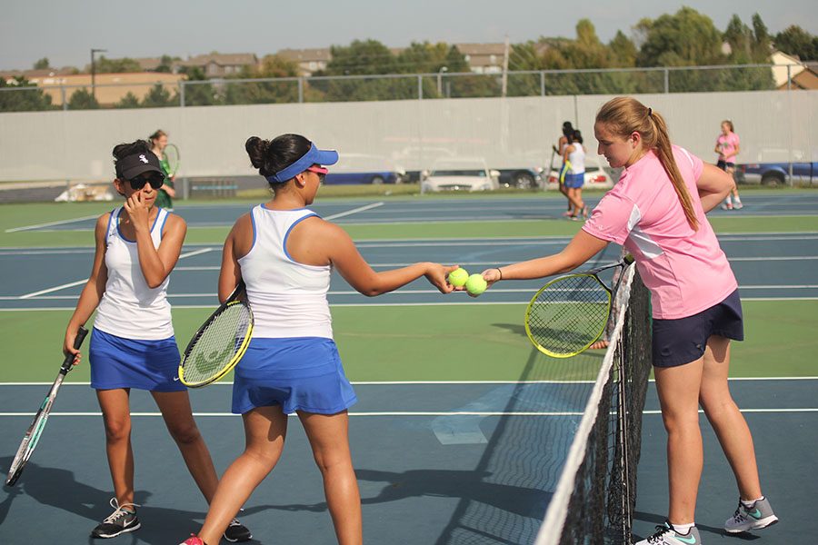 Senior Grace McGill retrieves the balls from her opponents. 