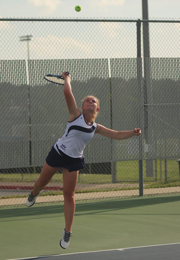 Junior Annie Casburn follows through on her serve.