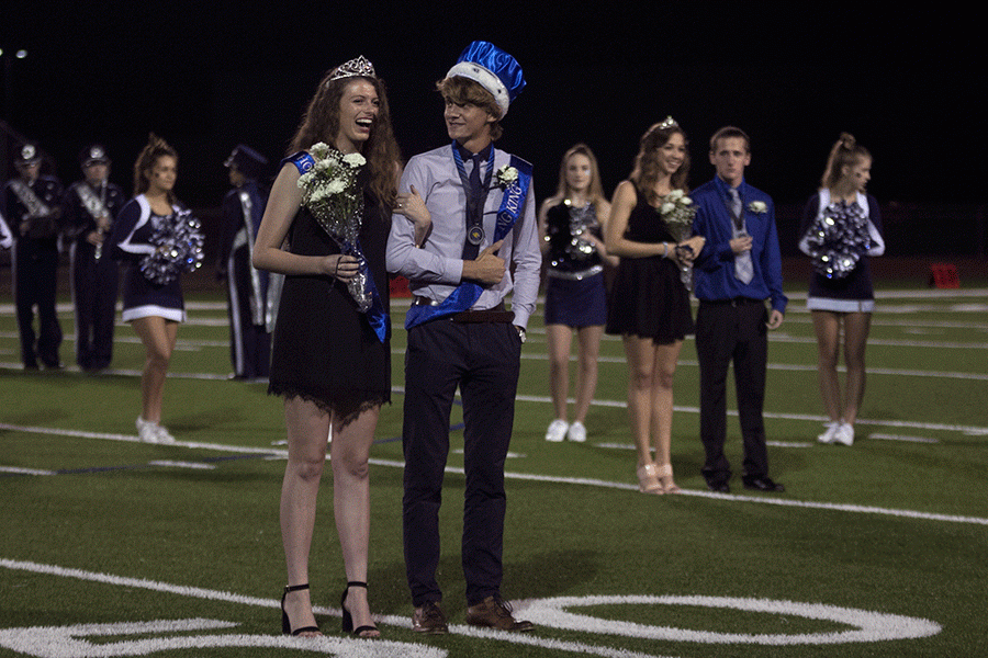 Seniors Maggie Bogart and Spencer Butterfield smile after being crowned Homecoming king and queen on Friday, Sept. 16.