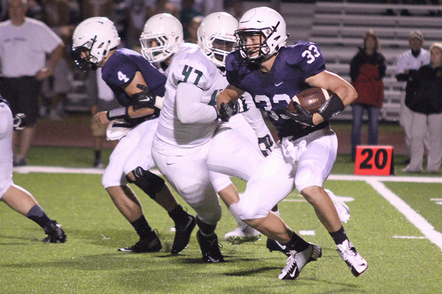 While playing running back, senior Tristan Milne carries the ball during the Homecoming game on September 18th, 2015. 