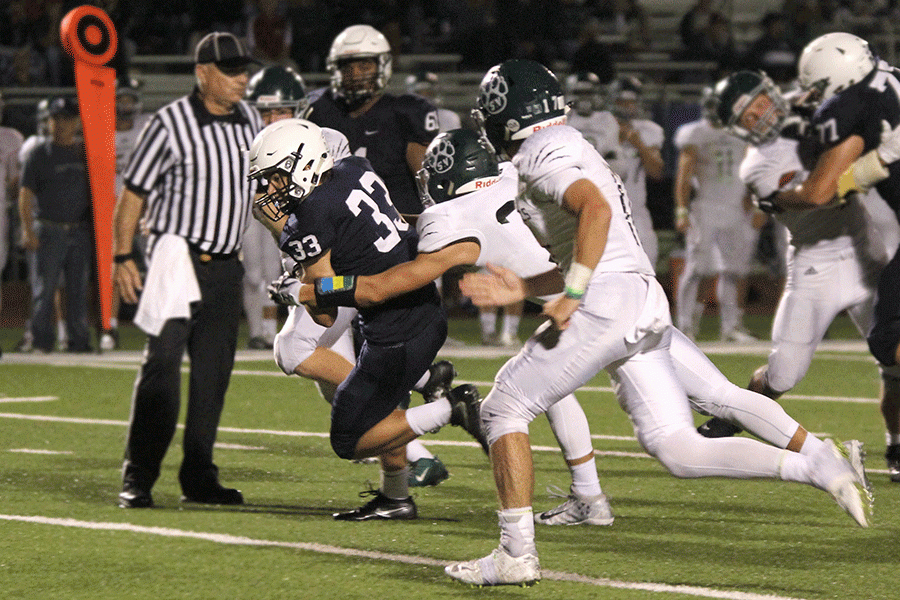 Attempting to avoid the defenders, sophomore Trevor Wieschhaus tries to run down the field. 