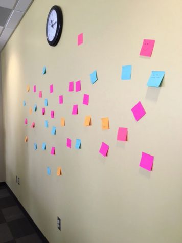 The people at the conference made a wall of sticky notes that had motivating messages on them to help lift the spirits of the others who were there.