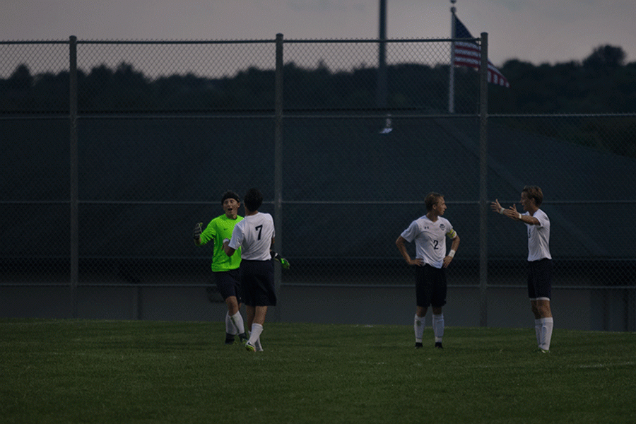 Mill Valley soccer players discuss a potentially incorrect call made by a referee.
