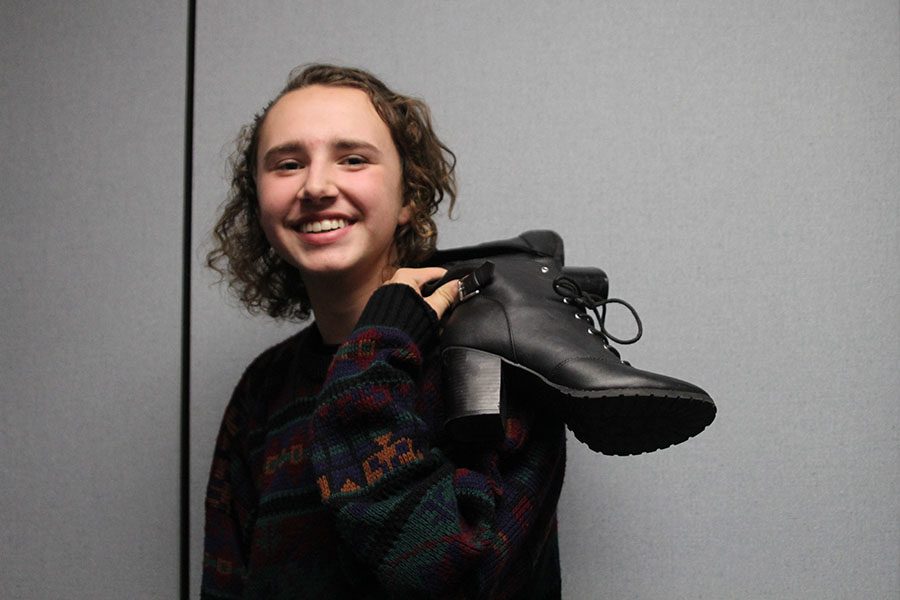 Standing with his shoe on Thursday, Oct. 20, junior Parker Johnson shows off his style. I have shoes that make me comfortable with my step, Johnson said. 