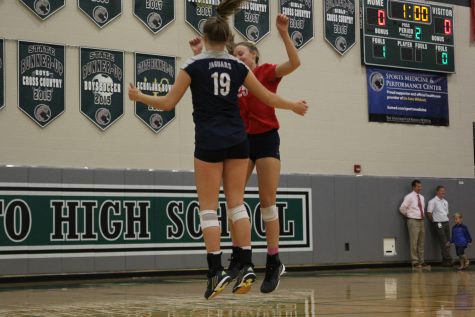 Getting ready before a play, sophomore Adele Warford and sophomore Sydney Pollen pump each other up by cheering words of encouragement.