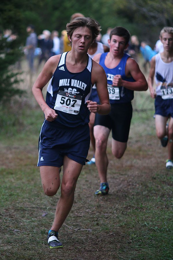 Junior Tyler Coad rounds the corner during the race at the Blue Valley Nature Park. Coad placed 9th overall.