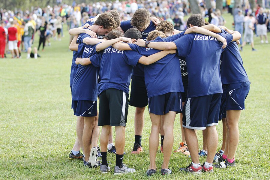 Huddling before their race, the boys team prepares to run the course at Rim Rock Farms.