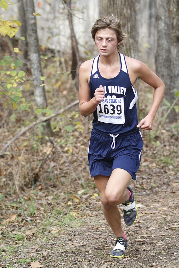 Junior Tyler Coad keeps a steady pace while running through the three mile course. Coad placed 12th at the state meet.