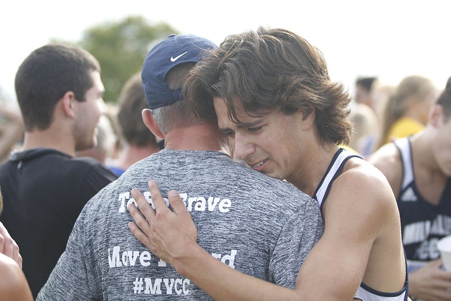After the race, Overbeck hugs coach Chris McAfee. Overbeck placed 22nd.