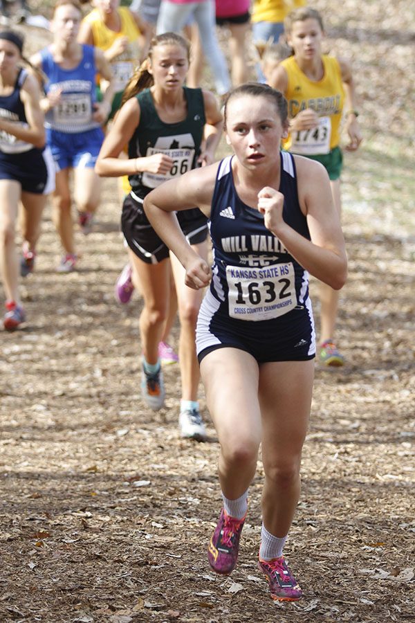 Sophomore Delaney Kemp races up a hill before placing  36th.