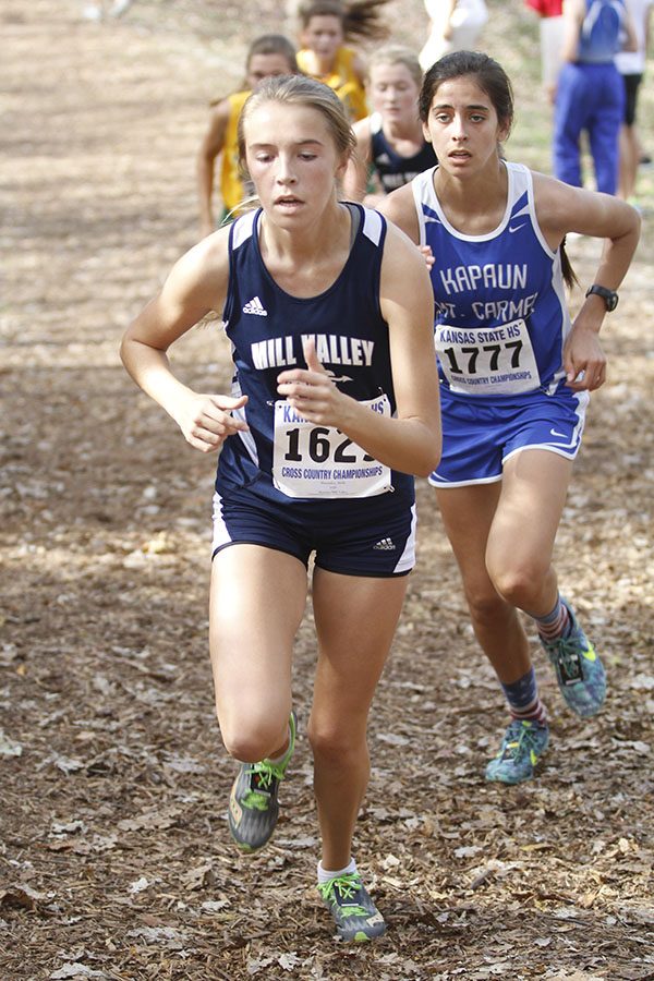 Freshman Molly Haymaker stays ahead of her competitors while running up a hill. Haymaker placed 47th at the meet.