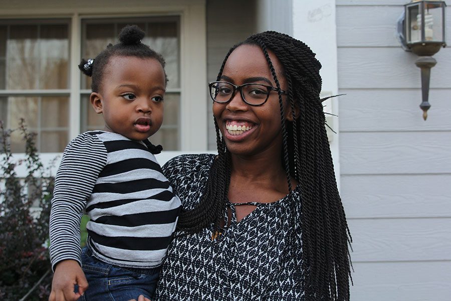 Senior Charlotte Muttai stands outside of her house, holding her two year old sister Arianna Muttai on Tuesday, Oct. 18. “I’ve always liked kids, so I feel like [pediatrics] would be a good place to start out and then maybe branch out into more specialties like the NICU,” said Charlotte Muttai.