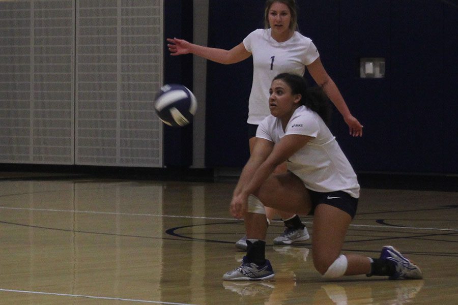 Sophomore Sydney Pullen takes a knee to bump the ball.