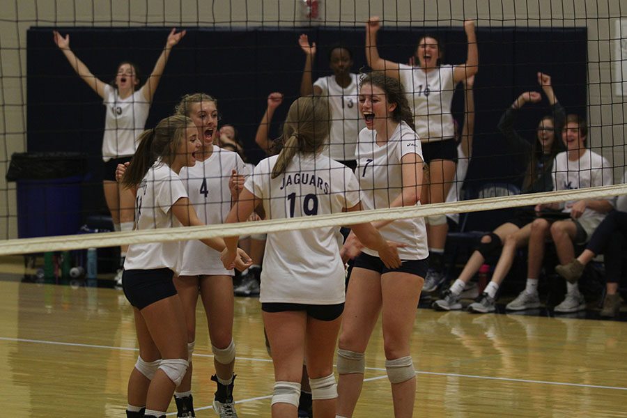 Senior Maggie Bogart celebrates a win with her teammates.