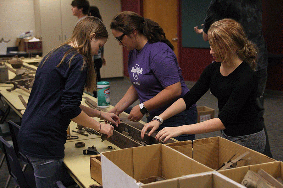 Juniors Marissa Olin and Chandler Randolph help sort donated tools with senior Meghan Clark in Archaeology class on Tuesday, Oct. 4.