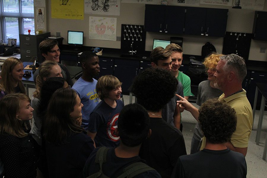 Science Olympiad members gather around sponsor Chad Brown for a team huddle on Tuesday, Oct. 4.