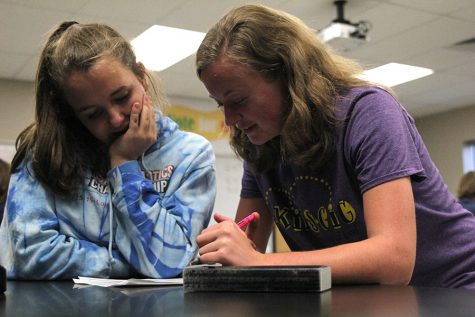 Sophomores Sydney Clarkin and Ambria Shawger read over science olympiad rules at practice on Tuesday, Oct. 4.