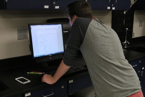 Freshman Noah Hookstra helps run tests for the experimental design team at Science Olympiad practice on Tuesday, Oct. 4.