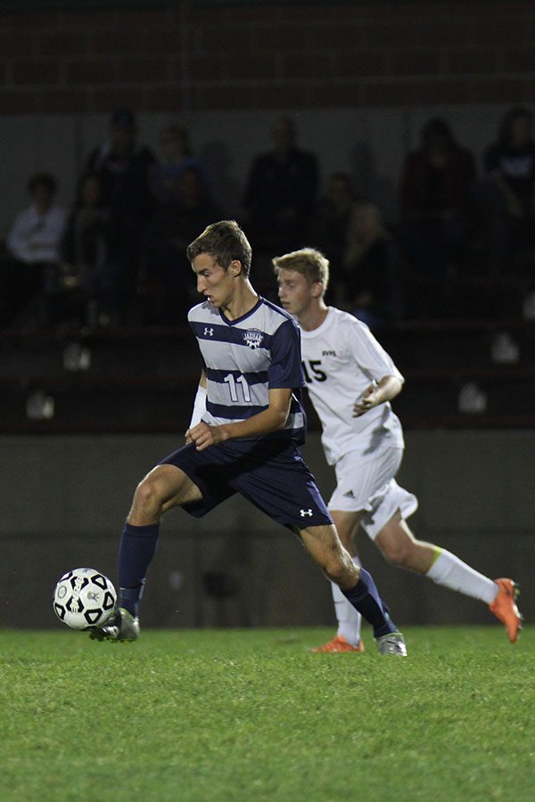 Winning possession of the ball, sophomore Jake Ashford controls the ball.