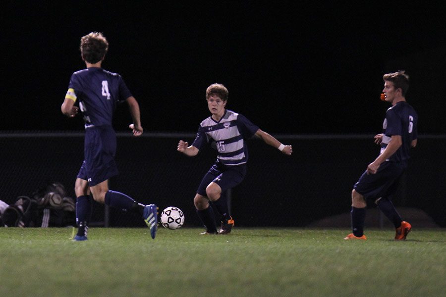 Sophomore Brock Denney passes the ball to senior Adam Grube.