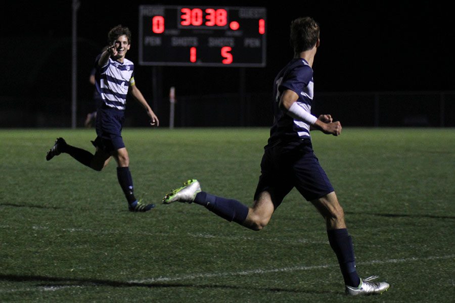 After sophomore Jake Ashford scored, senior Adam Grube celebrates by pointing at Ashford.