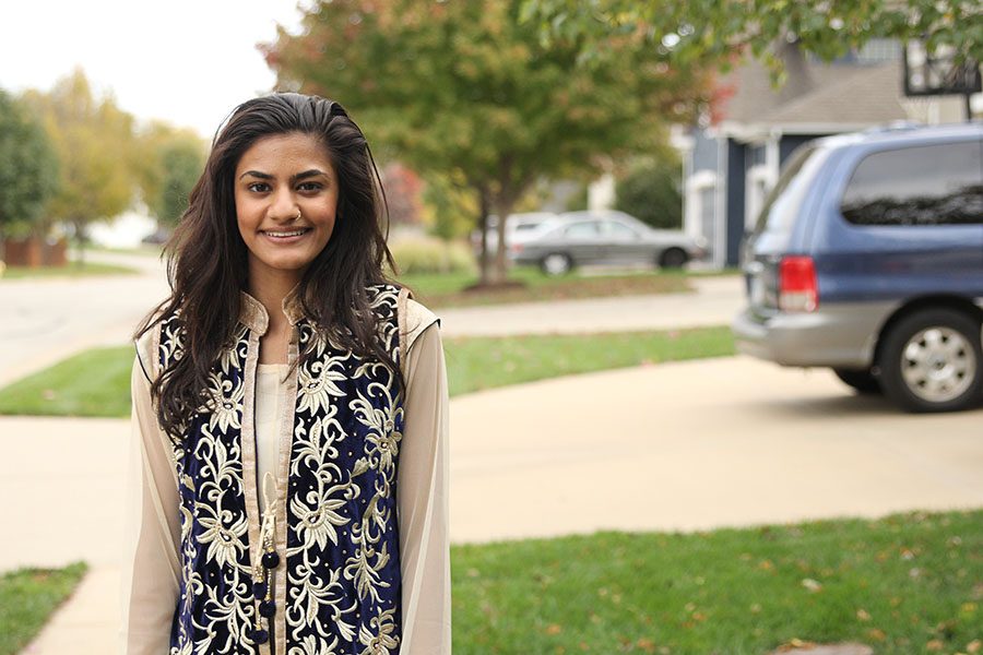 Standing in her driveway wearing her Indian suit on a Wednesday Oct. 19th, junior Shanu Kaushal explains every day life. Growing up has been extremely difficult, because of the two conflicting cultures, I try to balance both of them out. Kaushal said