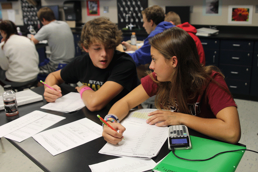 Completing a worksheet in Chemistry on Monday, Oct 4, sophomores Tanner Moore and Grace Davis lean in to talk to one another. “Mrs. Lloyd slows things down and really helps us understand what we are talking about,” Moore said.
