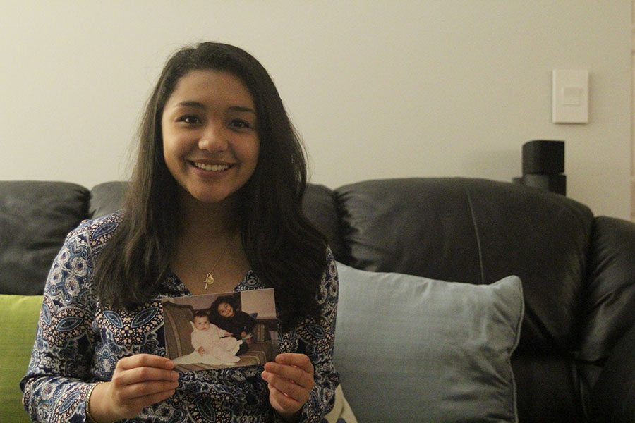 Junior Sofia Torres holds a picture of her and her cousin in Mexico while sitting on her couch on Wednesday, Oct. 12.
. “I really miss my family. Sometimes I don’t even know what to miss because they were never in my life a lot.”