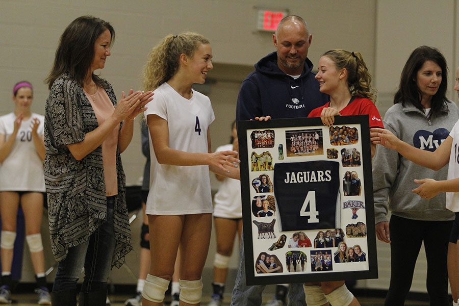 Senior Morgan Thomas receives her senior gift from freshman Emma Fox.