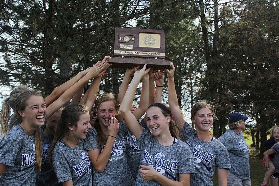 The girls hold up their third place trophy after the awards ceremony.