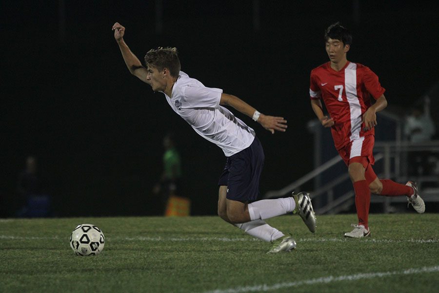 Sophomore Caleb Brown sprints toward the ball to keep possession. 