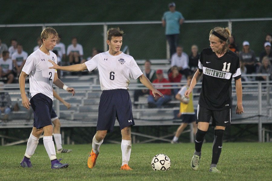 Attempting to relieve the tension during the game, senior Sam Lopez calmly walks between two players.