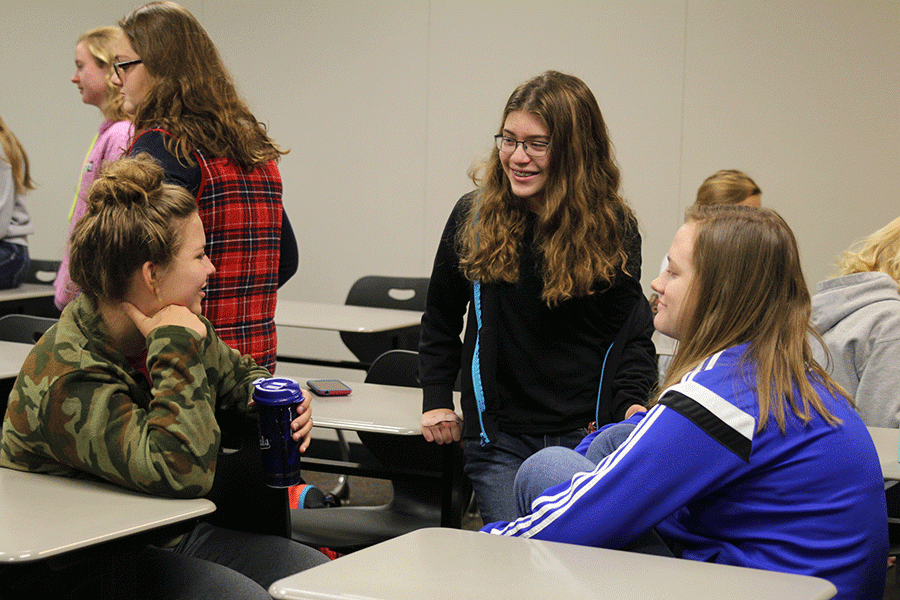 During a Club 121 meeting on the morning of Friday, Oct. 21, freshmen Kaleigh Johnston and Eva Burke  and senior Sarah McLaughlin have a group discussion and share their personal testimonies.