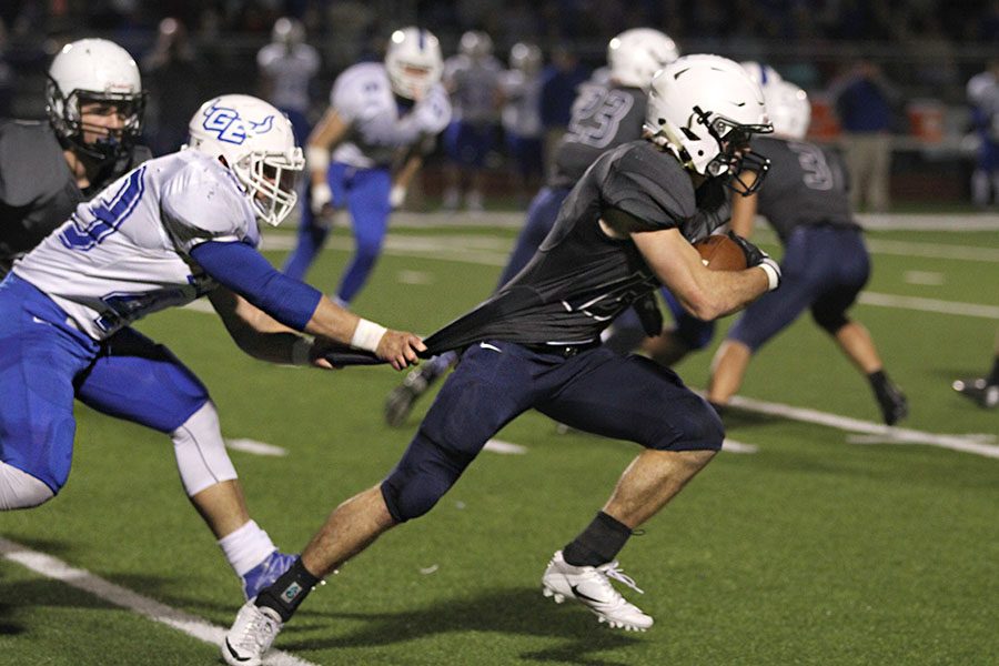 Senior Joel Donn continues to run despite being dragged back by his opponent on Friday, Oct. 21. The Jaguars beat Gardner-Edgerton 28-21. 