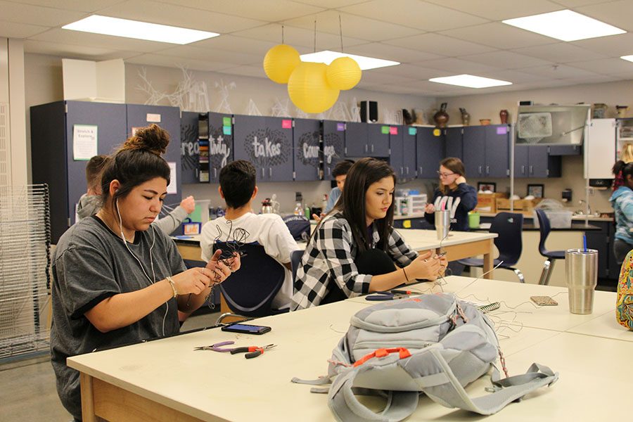 Seniors Alina Ruiz-Garcia and Natalie Carerra try to make their sculptures more stable on Tuesday, Oct. 25.