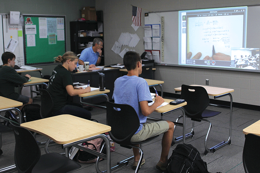 De Soto juniors Elizabeth Seidl, Cody Moose and Zach Deibert listen attentively to Mill Valley math teacher, Brian Rodkey via Zoom on Wednesday Oct. 12.