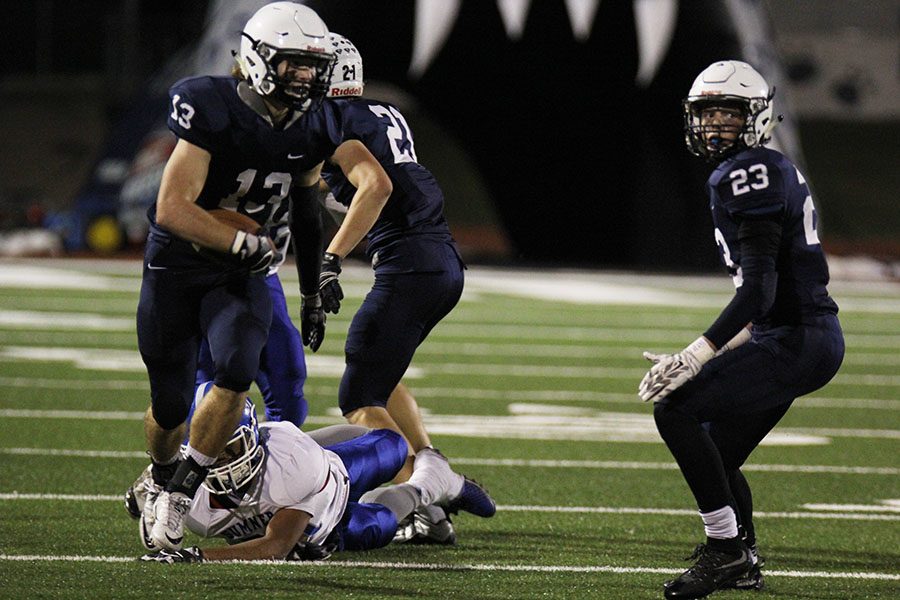 Running with the ball, senior defensive back Joel Donn dodges a tackle on Friday, Oct. 28 against Sumner Academy. 