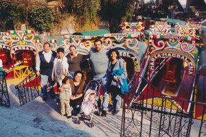 Torres stands with members of her family in front of trajineras. (submitted photo)